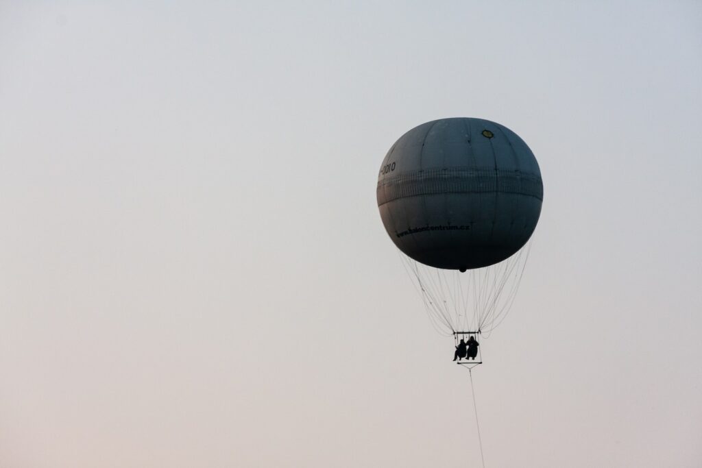 black hot air balloon in the sky