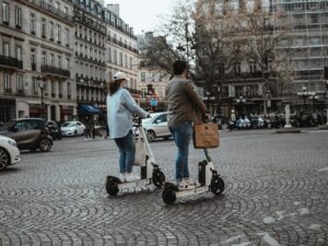 man in white dress shirt and blue denim jeans holding black and red shopping cart on near on near on