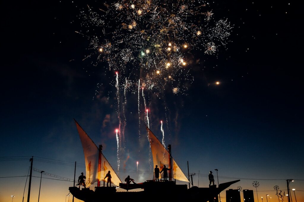 silhouette photography of person standing while watching fireworks in the sky